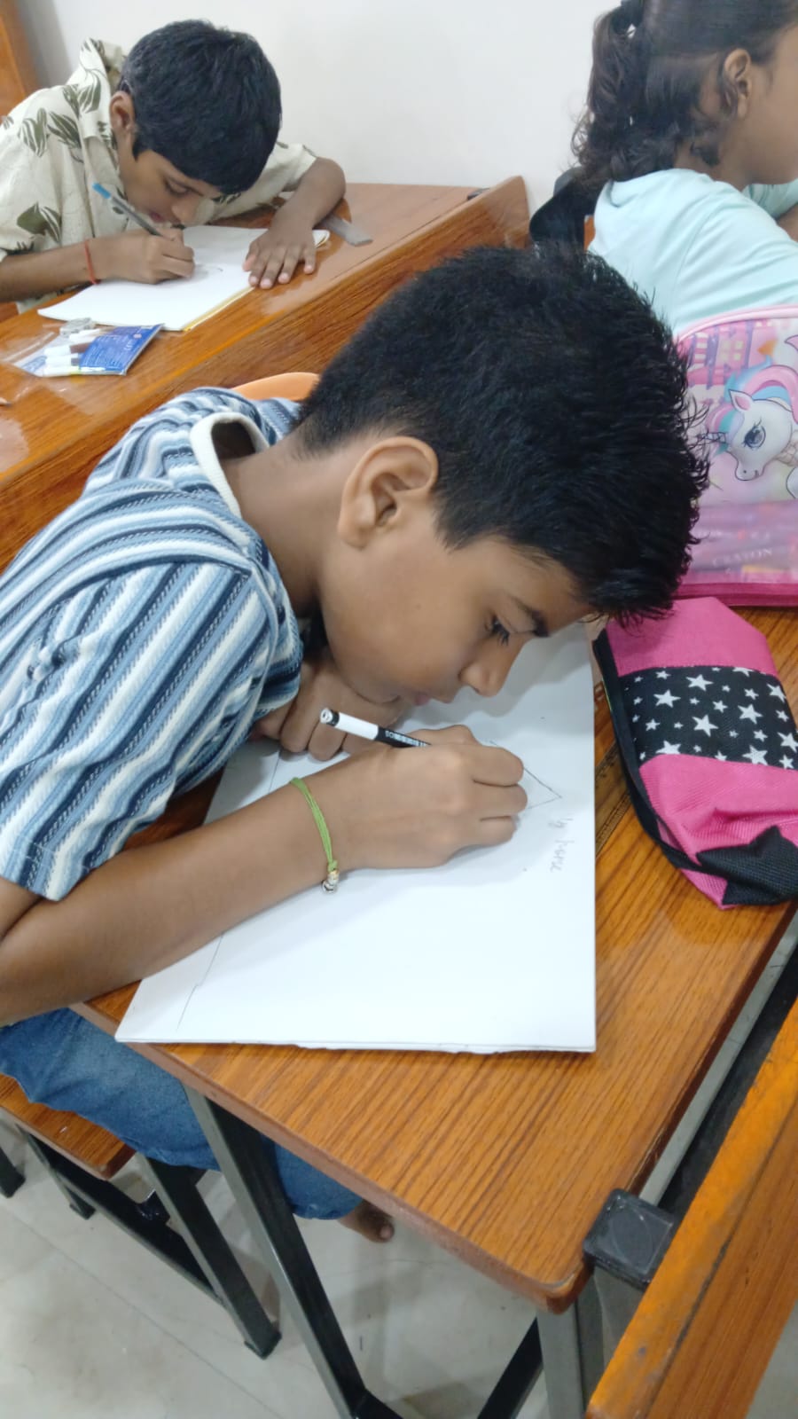 Student concentrating on drawing at art therapy session, Nagpur